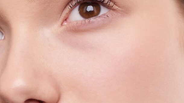 Close-up portrait capturing the natural beauty and smooth skin of a young woman.