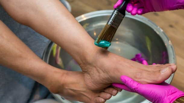 person holding brush and foot